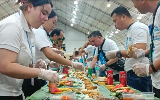 Filipino Seafarers Honored as Philippines Celebrates World Maritime Week Filipino seafarers partake in a boodle fight prepared by the Department of Migrant Workers