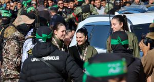 Hostage-Prisoner Swap Unfolds Amidst Gaza Ceasefire Hamas fighters escort four Israeli hostages